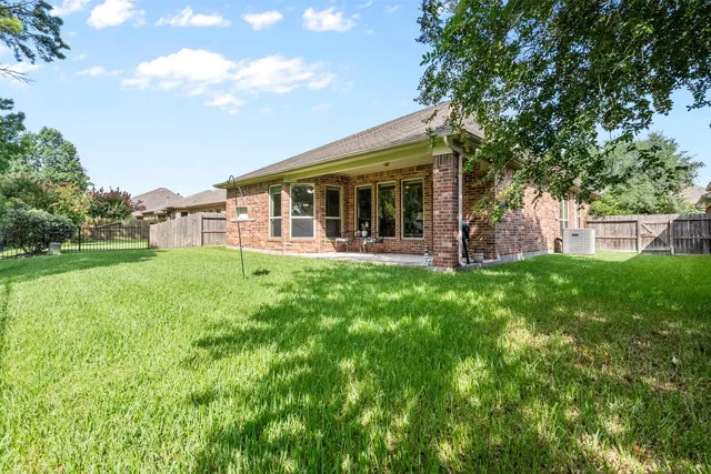 a view of a house with a yard and sitting area