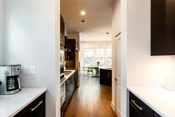 a kitchen with a sink appliances and cabinets
