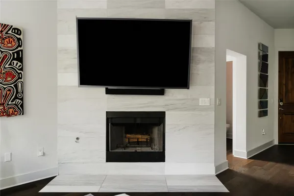 a living room with a fireplace and a flat screen tv