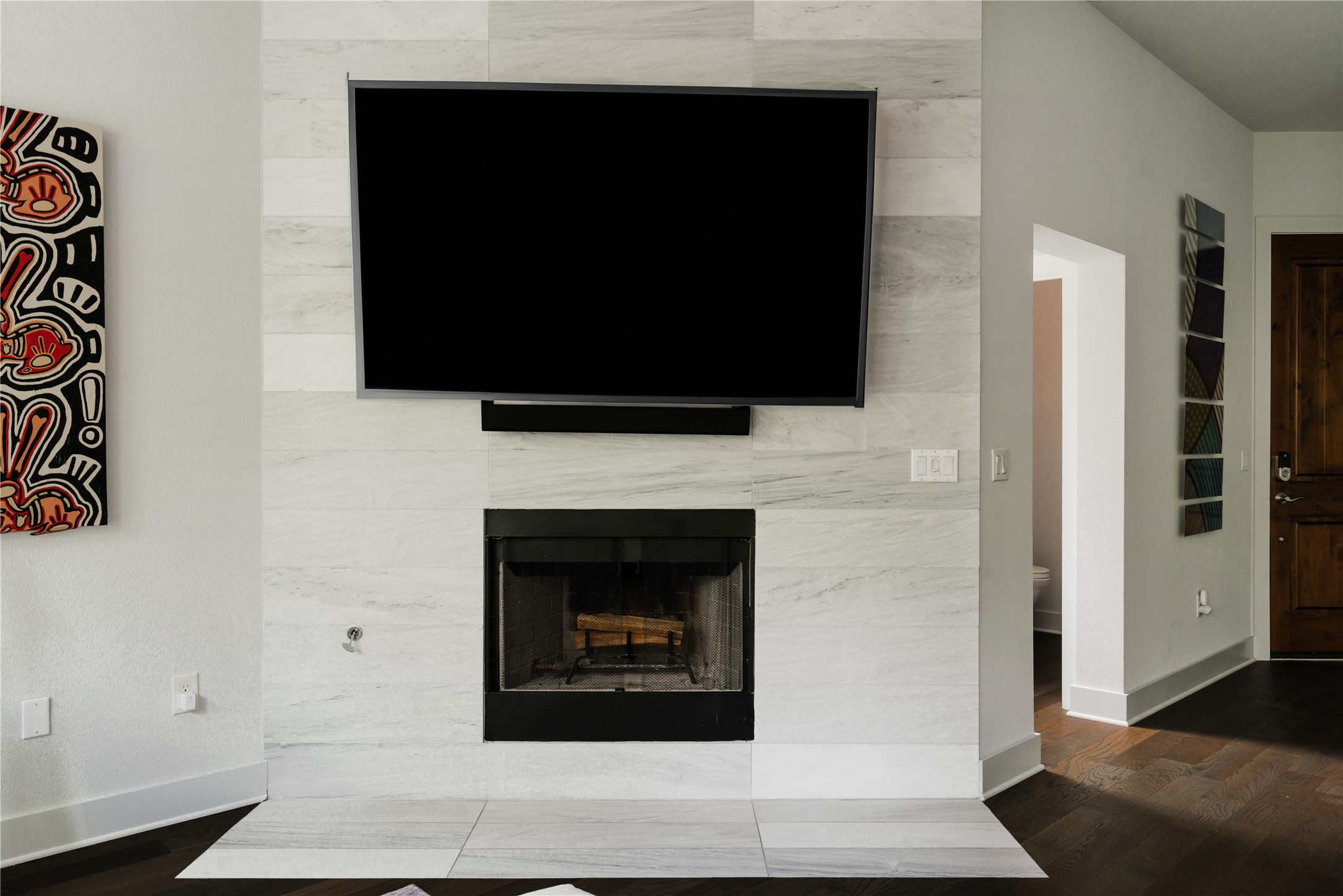 8110 Ranch Road 2222, Unit 36 Austin, TX 78730 - Photo 19 of 31 a living room with a fireplace and a flat screen tv