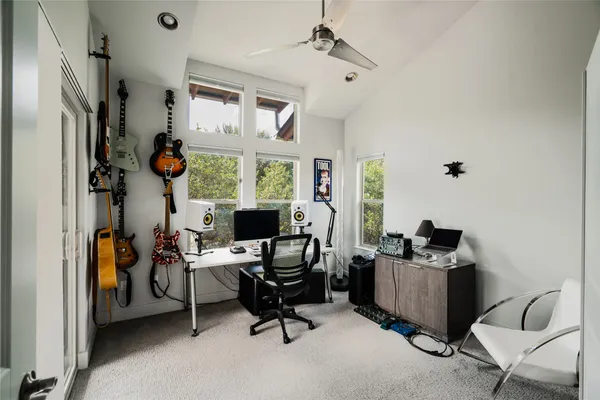 a view of a workspace with furniture and a window