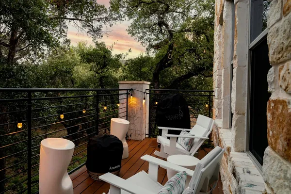 a view of balcony with couch and chairs