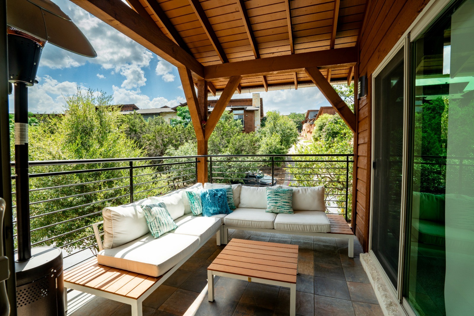 8110 Ranch Road 2222, Unit 36 Austin, TX 78730 - Photo 5 of 31 a balcony with wooden floor and outdoor seating