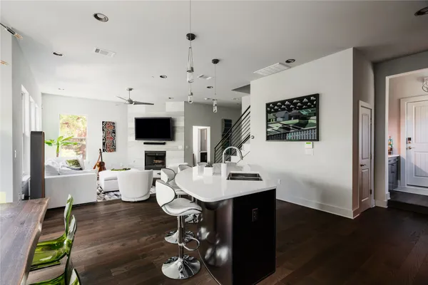 a living room with dining room and wooden floor