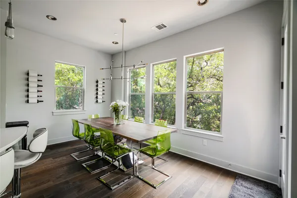 a dining room with wooden floor and a window