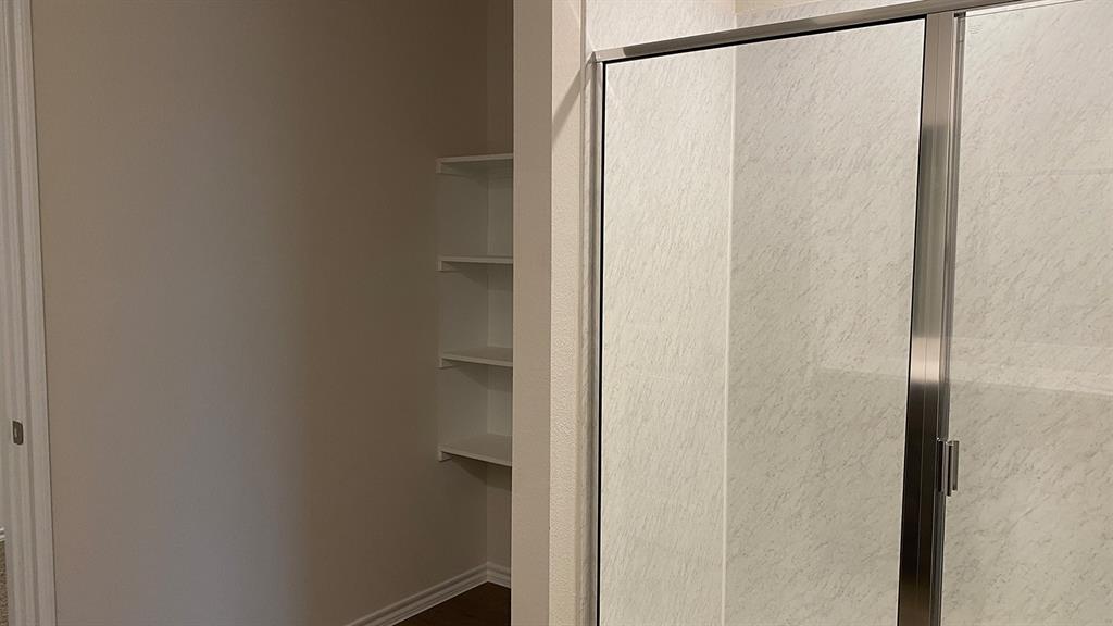 107 Hunters Way Canton, TX 75103 - Photo 18 of 23 a bathroom with a glass shower door