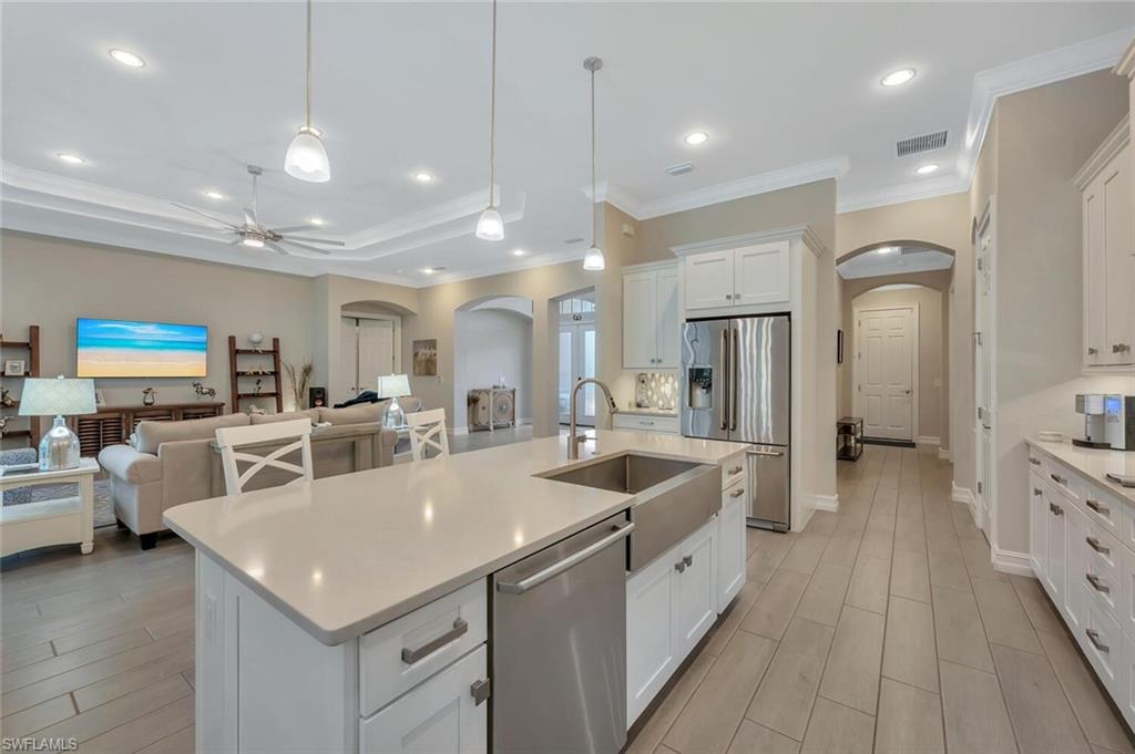 1451 Mockingbird Drive Naples, FL 34120 - Photo 16 of 42 a large white kitchen with a large counter top appliances and furniture