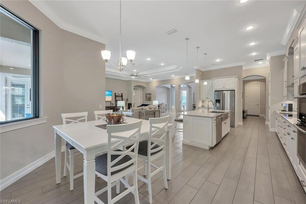1451 Mockingbird Drive Naples, FL 34120 - Photo 18 of 42 a large kitchen with a table and chairs