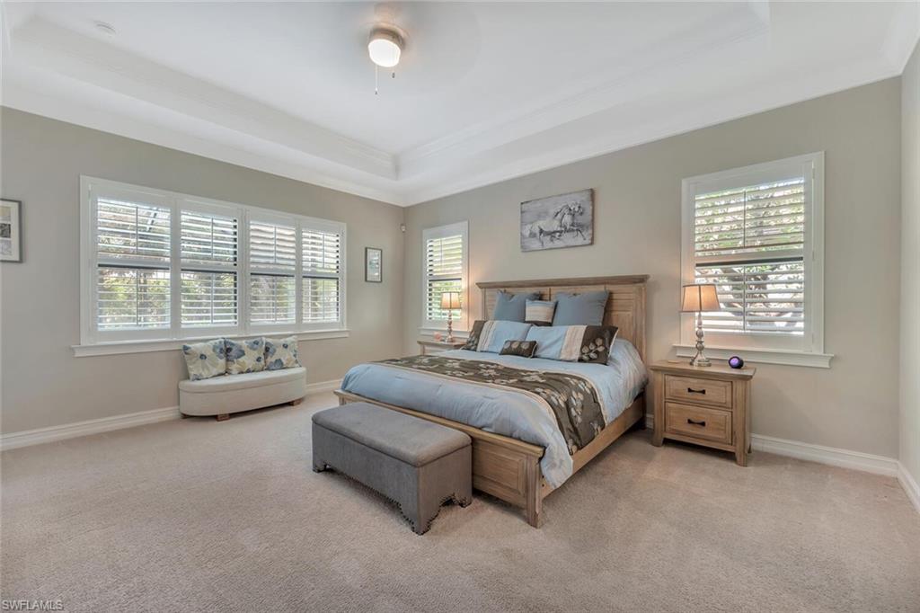 1451 Mockingbird Drive Naples, FL 34120 - Photo 23 of 42 a spacious bedroom with a bed and a couch