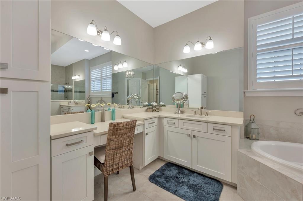 1451 Mockingbird Drive Naples, FL 34120 - Photo 27 of 42 a large bathroom with a sink a large mirror and a shower