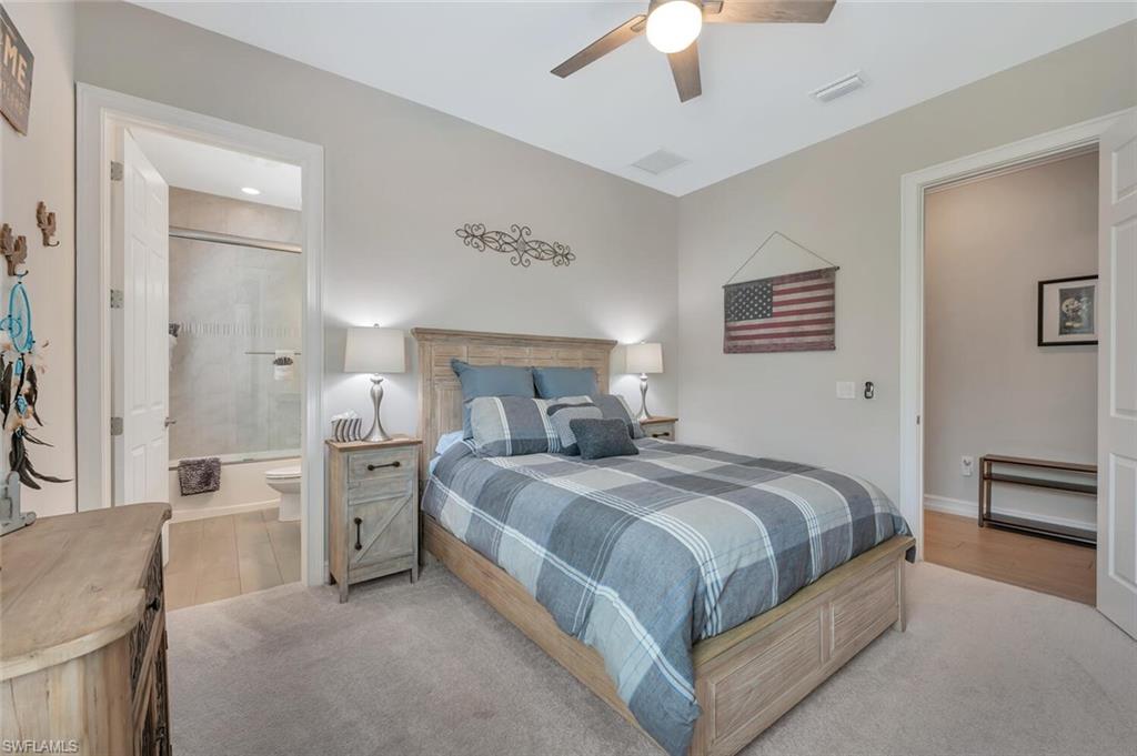 1451 Mockingbird Drive Naples, FL 34120 - Photo 32 of 42 a bedroom with a bed and a chandelier