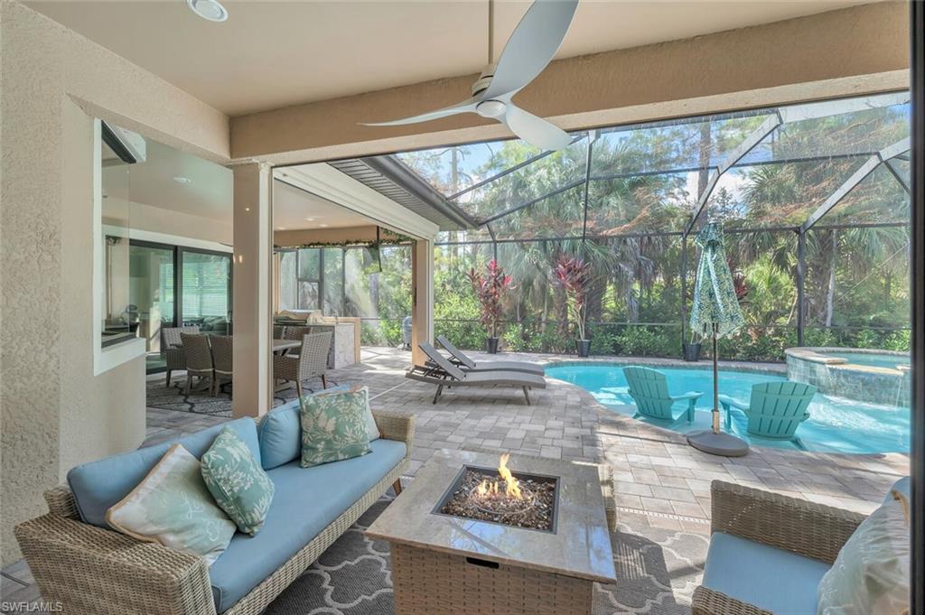 1451 Mockingbird Drive Naples, FL 34120 - Photo 34 of 42 a living room with couch and a large window