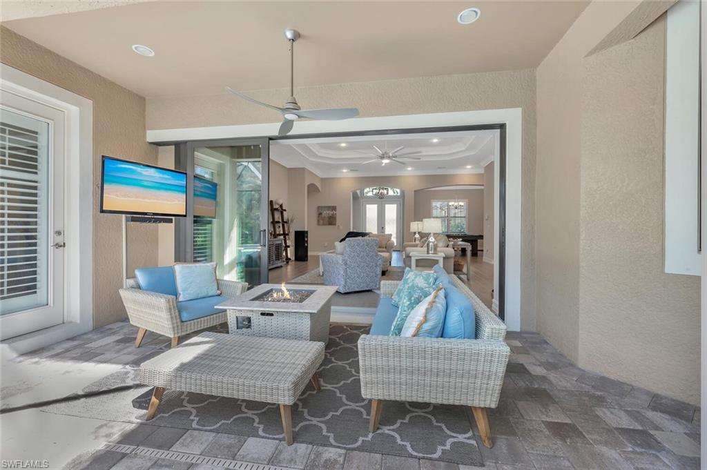 1451 Mockingbird Drive Naples, FL 34120 - Photo 42 of 42 a living room with furniture and a chandelier
