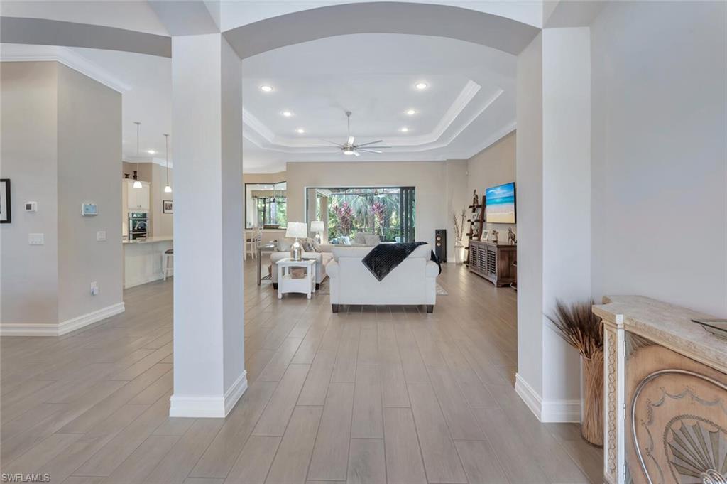 1451 Mockingbird Drive Naples, FL 34120 - Photo 5 of 42 a living room with furniture and a fireplace