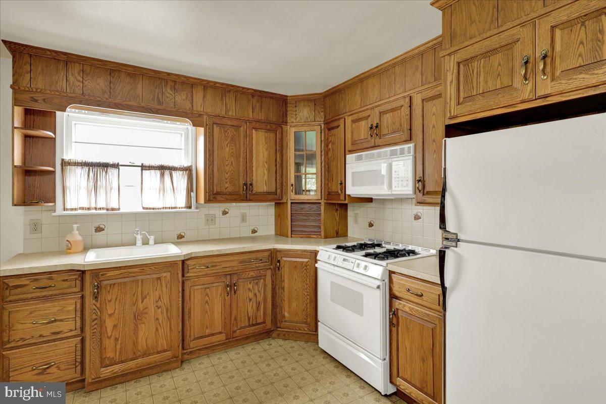 1224 Commonwealth Boulevard Reading, PA 19607 - Photo 11 of 27 a kitchen with stainless steel appliances granite countertop a sink stove and refrigerator