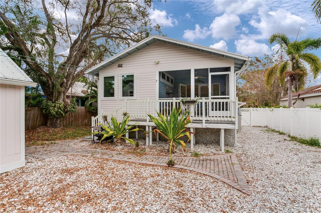 652 Ohio Place Sarasota, FL 34236 - Photo 46 of 61 a white house with a small yard and a large tree