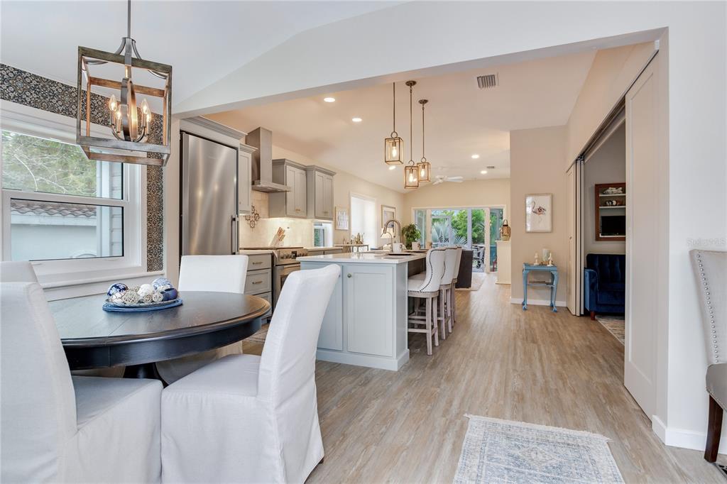 652 Ohio Place Sarasota, FL 34236 - Photo 6 of 61 a dining room with stainless steel appliances kitchen island a table and chairs