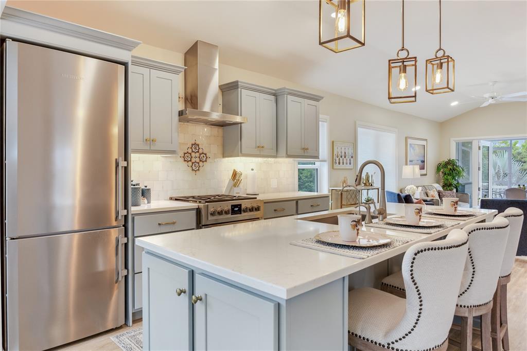 652 Ohio Place Sarasota, FL 34236 - Photo 10 of 61 a kitchen with stainless steel appliances granite countertop a sink a stove a refrigerator and cabinets