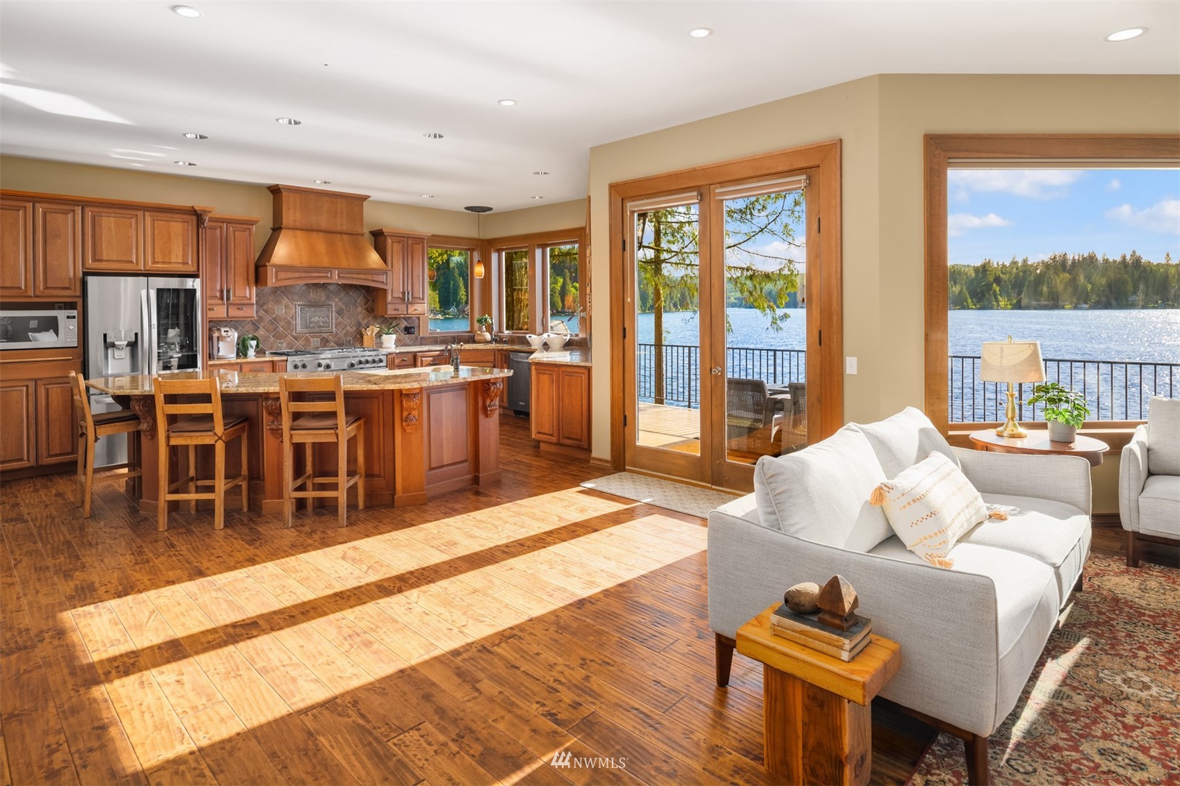 308 South Tulloch Road Snohomish, WA 98290 - Photo 4 of 40 a living room with furniture a wooden floor and a view of kitchen