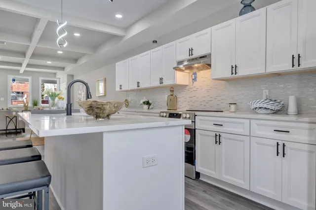 a kitchen with stainless steel appliances granite countertop a sink and wooden cabinets