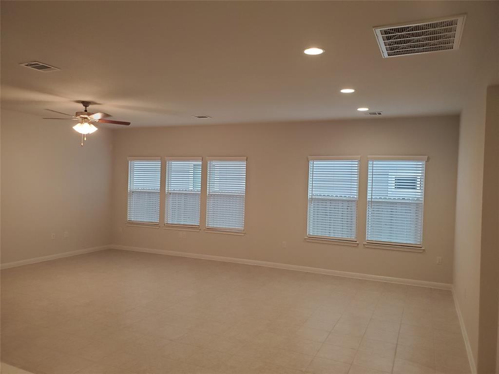 6404 Gunflint Drive Austin, TX 78747 - Photo 13 of 21 A versatile living area with a ceiling fan and abundant natural light.