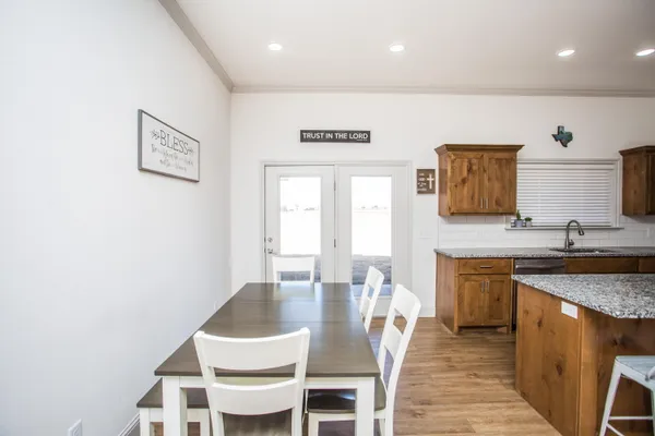 a large kitchen with a table and chairs in it