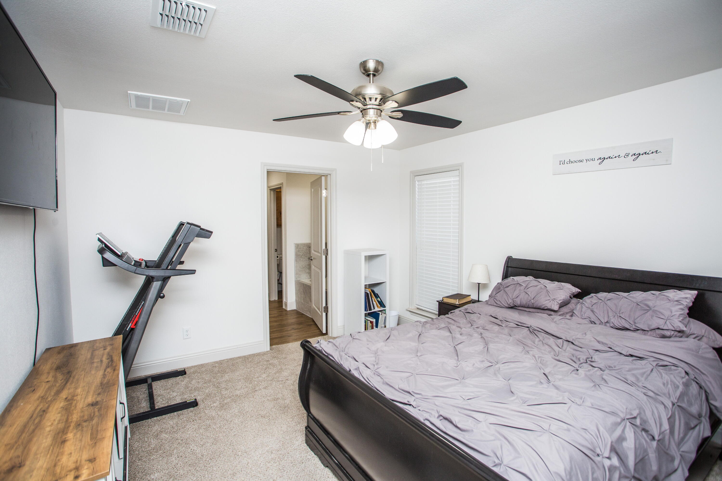 816 North 4th Street Wolfforth, TX 79382 - Photo 14 of 25 a bedroom with a bed and a ceiling fan