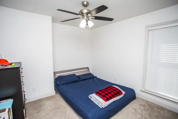 a view of room with a ceiling fan and a rug