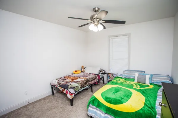 a bedroom with bed and a chandelier