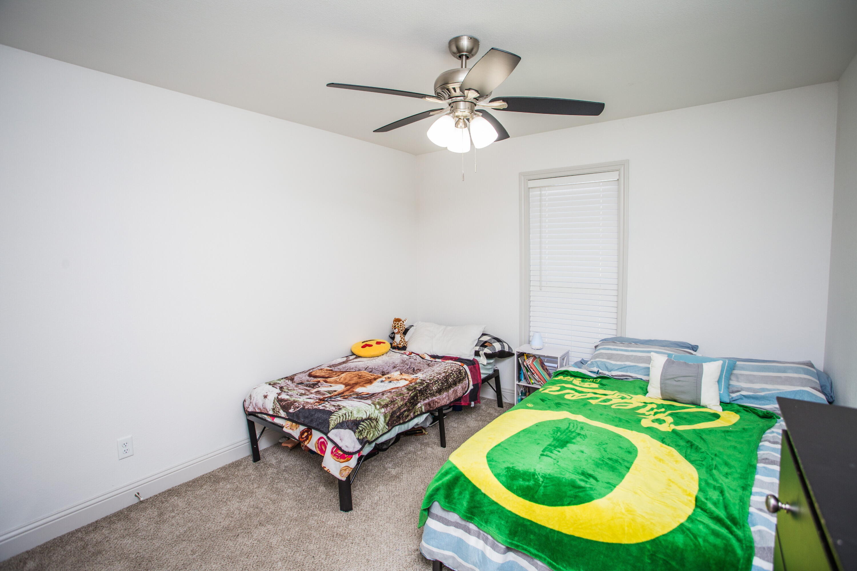 816 North 4th Street Wolfforth, TX 79382 - Photo 19 of 25 a bedroom with bed and a chandelier