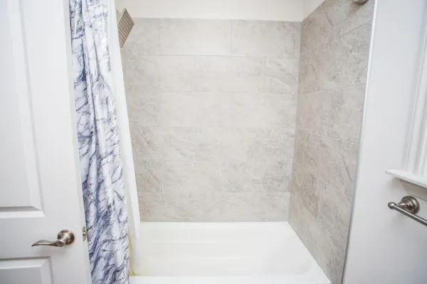 a bathroom with a shower curtain and a bathtub