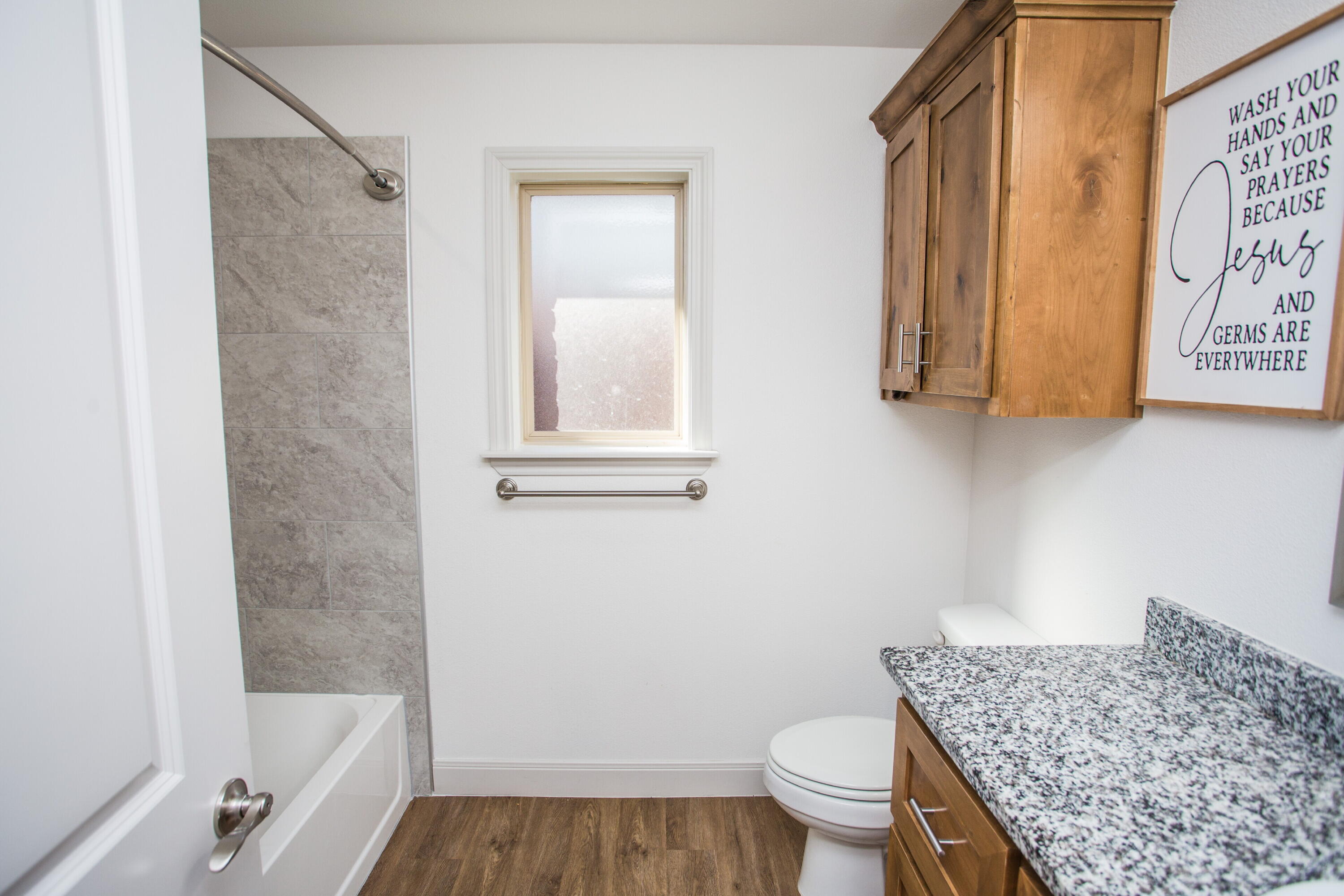 816 North 4th Street Wolfforth, TX 79382 - Photo 22 of 25 a bathroom with a granite countertop bathtub shower sink and toilet