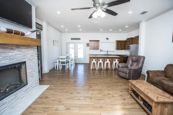 a living room with furniture and kitchen view