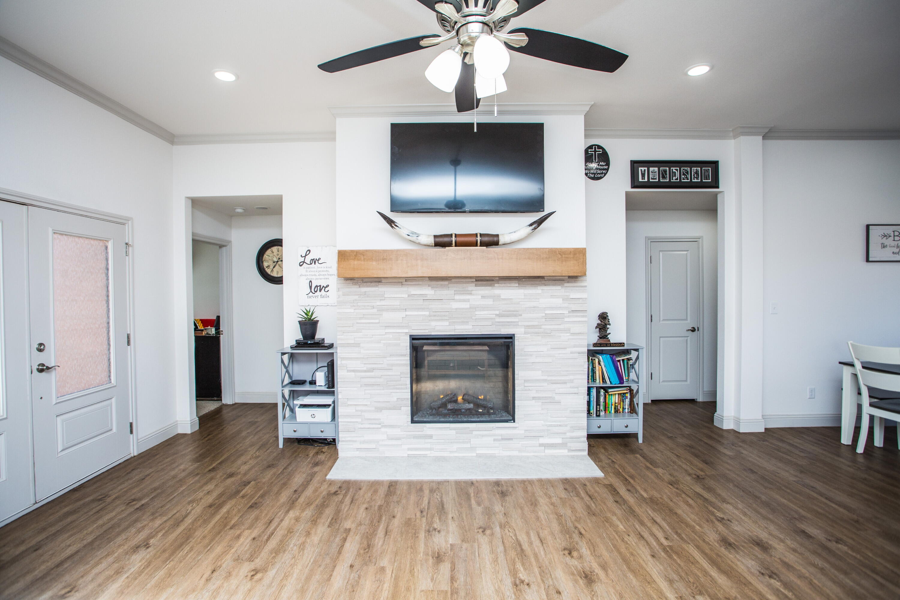 816 North 4th Street Wolfforth, TX 79382 - Photo 6 of 25 a living room with a fireplace and a flat screen tv
