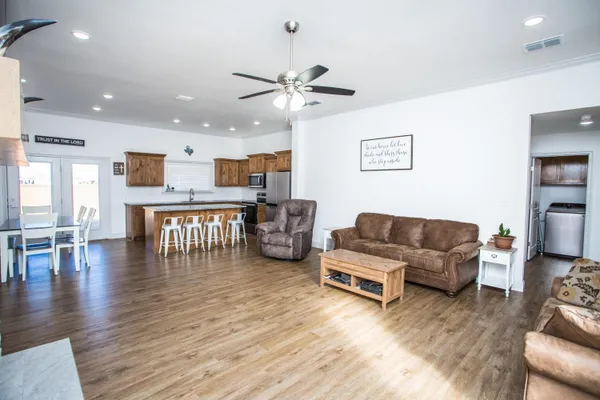 a living room with furniture and kitchen view
