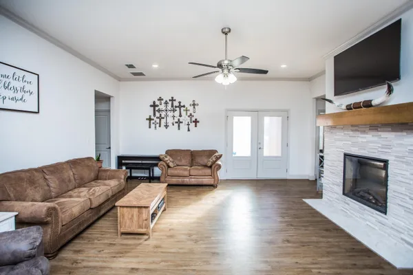 a living room with furniture ceiling fan and a fireplace