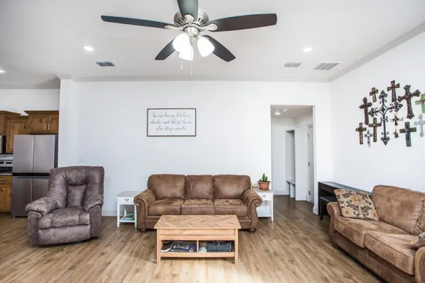 a living room with furniture and a wooden floor