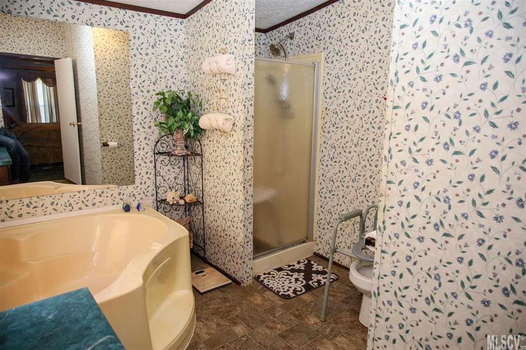 8843 Mull Road Vale, NC 28168 - Photo 11 of 25 a bathroom with a bathtub and shower