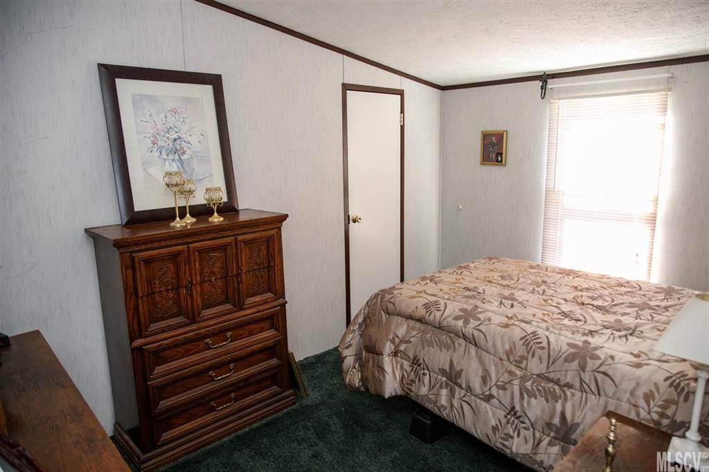 8843 Mull Road Vale, NC 28168 - Photo 12 of 25 a bedroom with a bed and a window