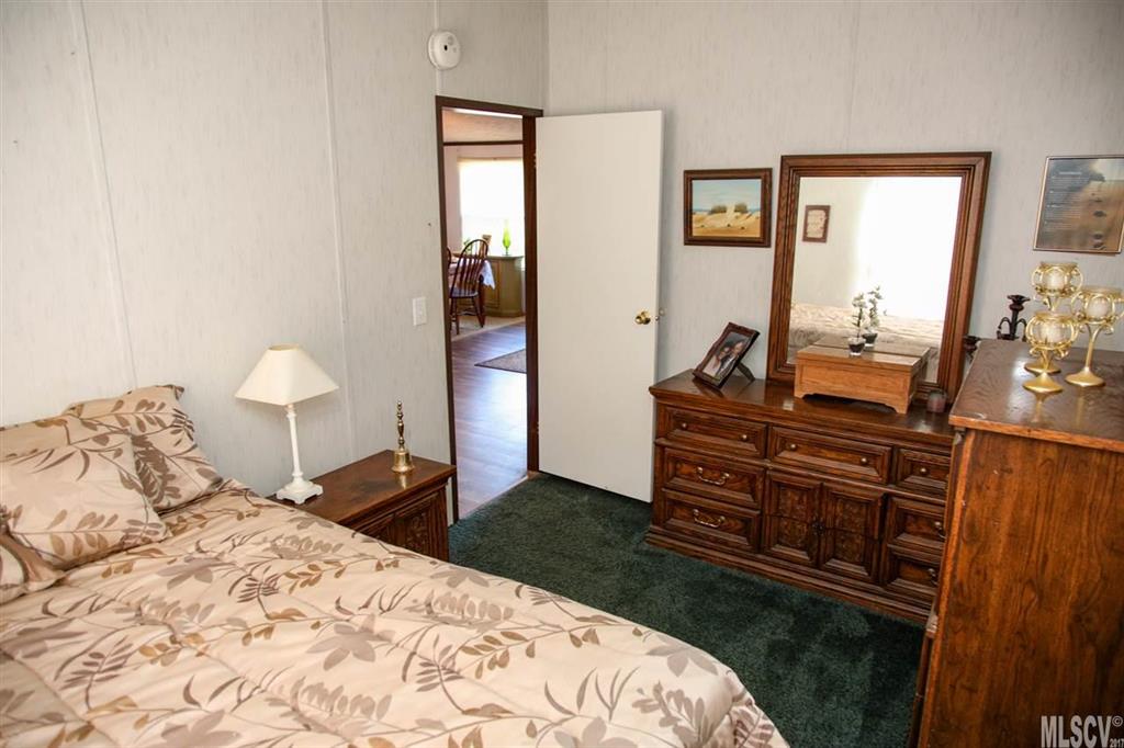 8843 Mull Road Vale, NC 28168 - Photo 14 of 25 a bedroom with a bed and wooden floor