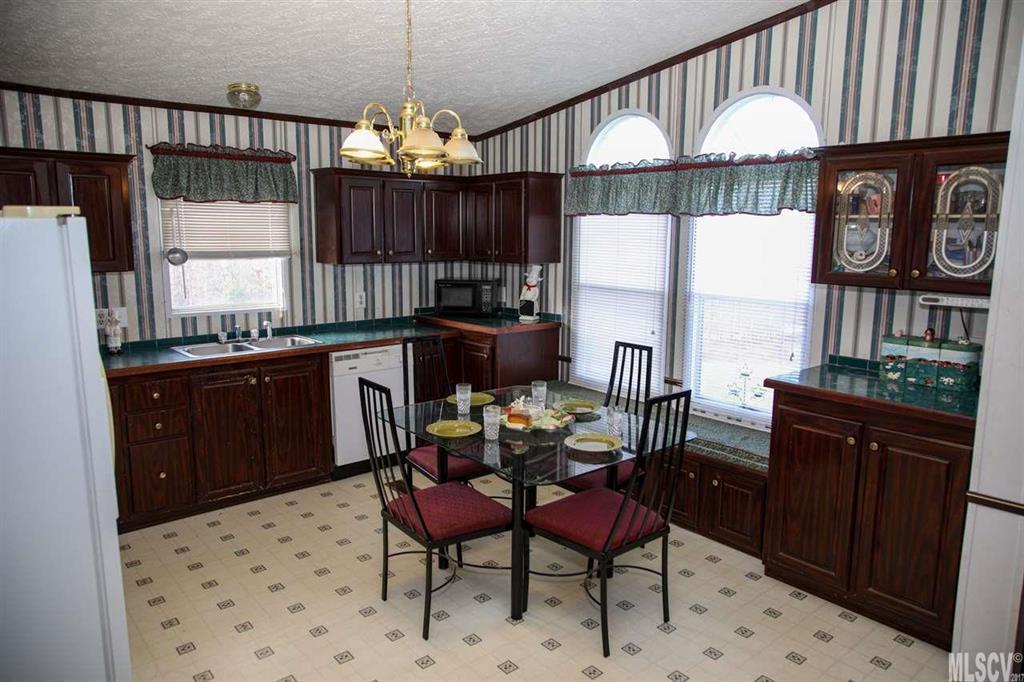 8843 Mull Road Vale, NC 28168 - Photo 5 of 25 a kitchen with a table chairs stove and cabinets