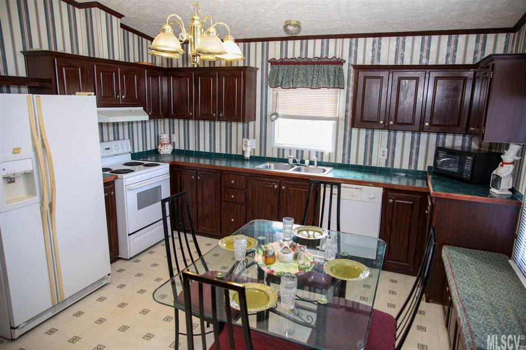 8843 Mull Road Vale, NC 28168 - Photo 6 of 25 a kitchen with stainless steel appliances granite countertop a stove a sink dishwasher and a refrigerator