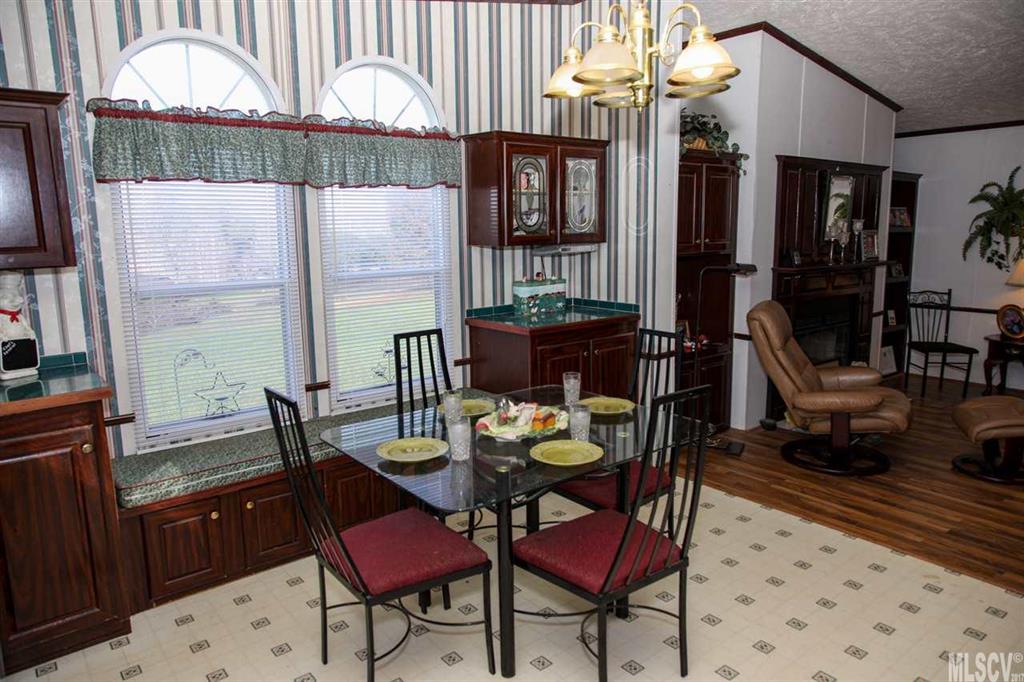 8843 Mull Road Vale, NC 28168 - Photo 7 of 25 a view of a dining room with furniture a chandelier and wooden floor