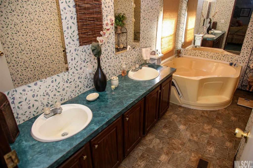 8843 Mull Road Vale, NC 28168 - Photo 10 of 25 a bathroom with a granite countertop sink and a mirror