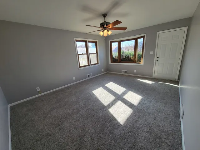 an empty room with windows and mountain view
