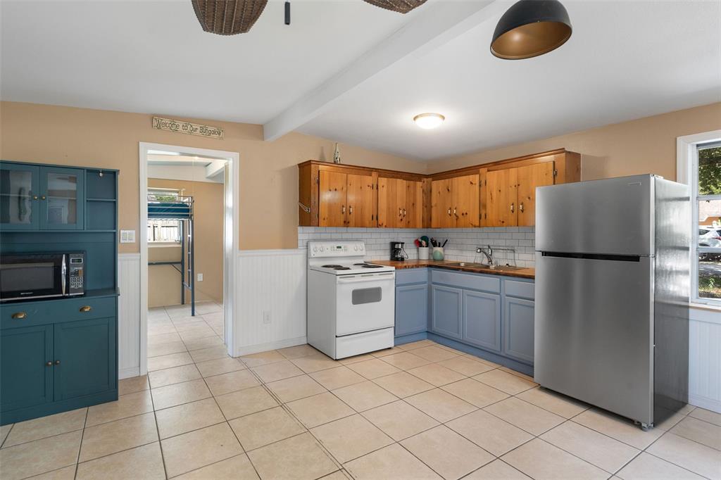 6129 Beacon Point Drive Weeki Wachee, FL 34607 - Photo 2 of 30 a kitchen with a refrigerator sink and cabinets