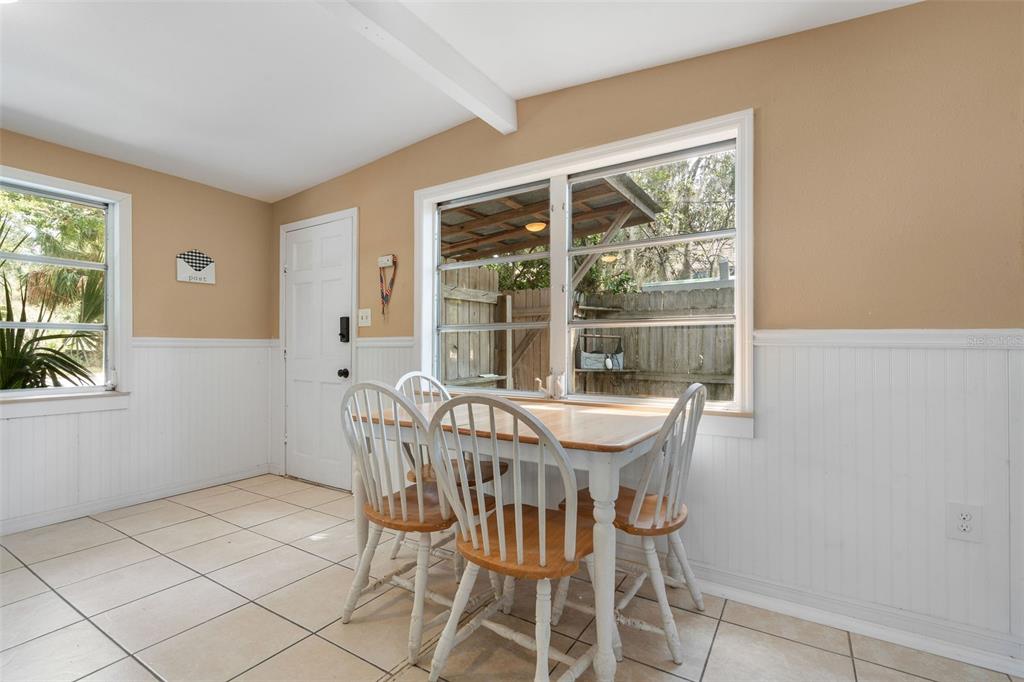 6129 Beacon Point Drive Weeki Wachee, FL 34607 - Photo 4 of 30 a view of a dining room with furniture large windows and wooden floor