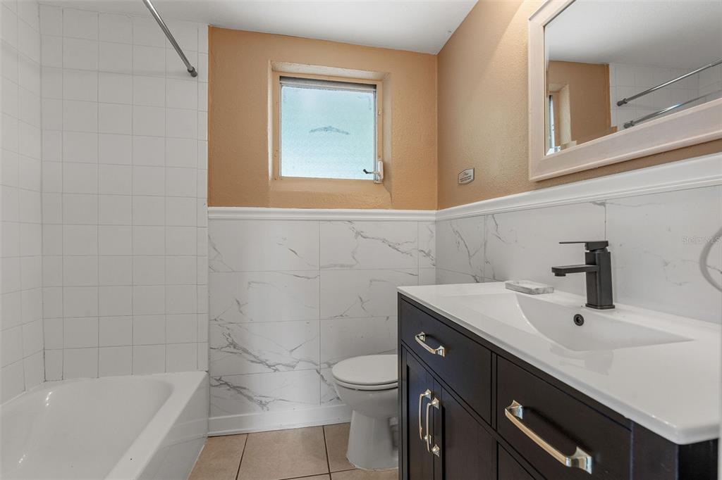 6129 Beacon Point Drive Weeki Wachee, FL 34607 - Photo 10 of 30 a bathroom with a sink toilet and vanity