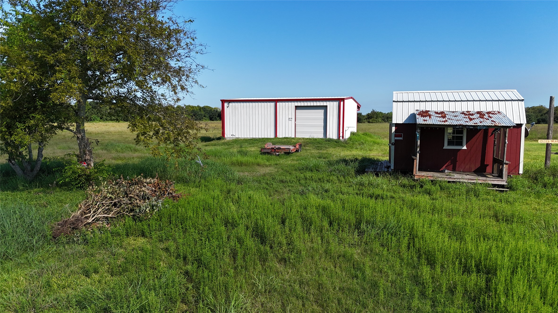 11705 Landrum Road Santa Fe, TX 77510 - Photo 3 of 13 30x40 red iron building to say. Red building and porch will be removed.