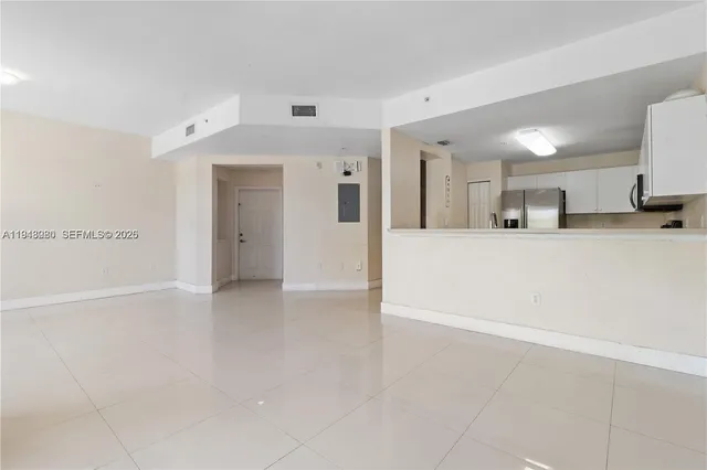 a view of a kitchen with a refrigerator and a sink